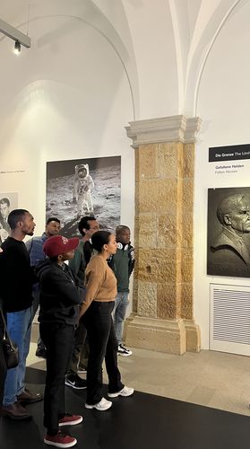 Students look at pictures in a wall in the Museum of Military History in Dresden. Photo: Enrico Behne